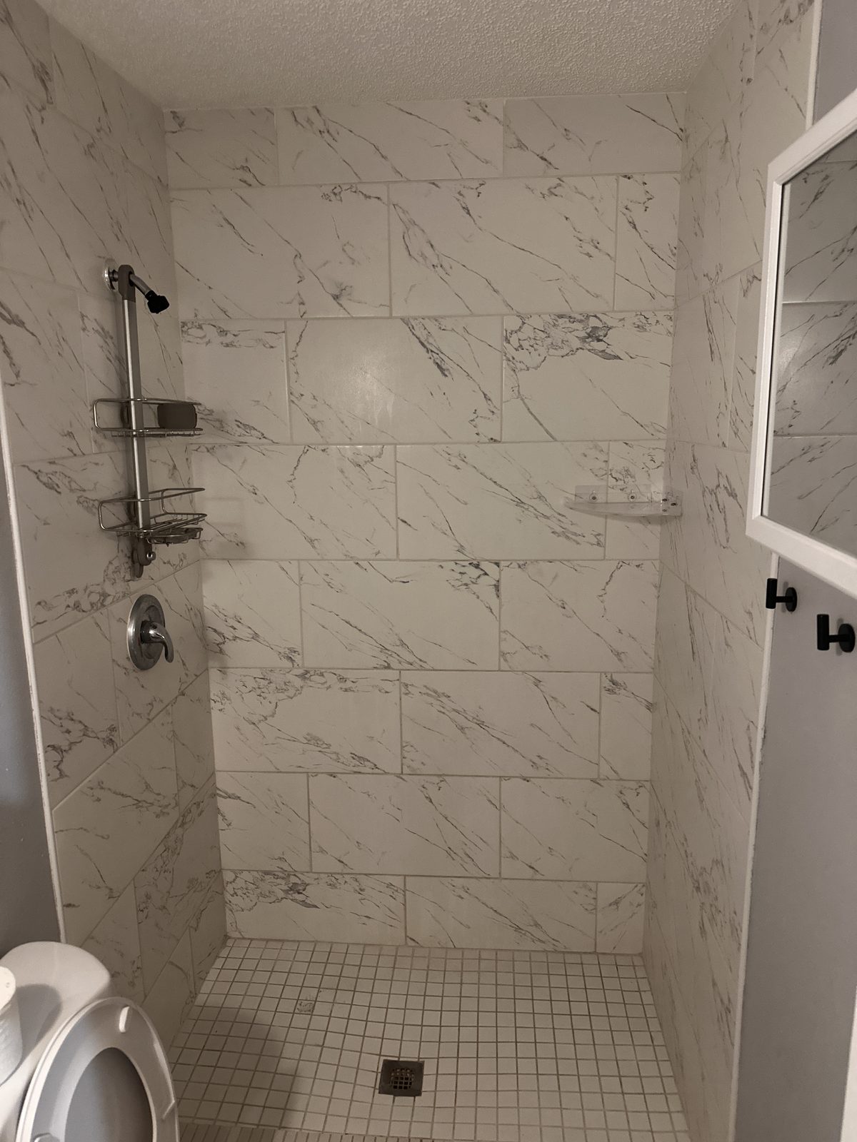Dated shower to gray large-format with frameless glass — Before